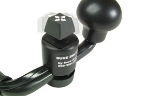 Close-up of a black Sure Switch device with a rotating knob and attached cables, used for controlling electronic equipment.