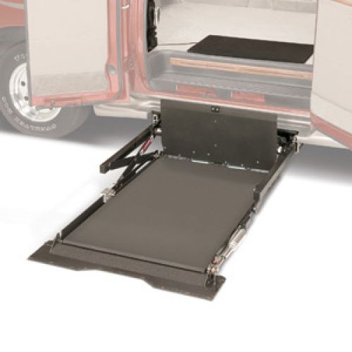A wheelchair lift is extended from the side door of a vehicle, providing an accessible ramp for easy entry and exit.