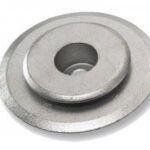 A metal washer with a central hole and a slightly raised inner ring, often used in mechanical assemblies to distribute the load of a threaded fastener.